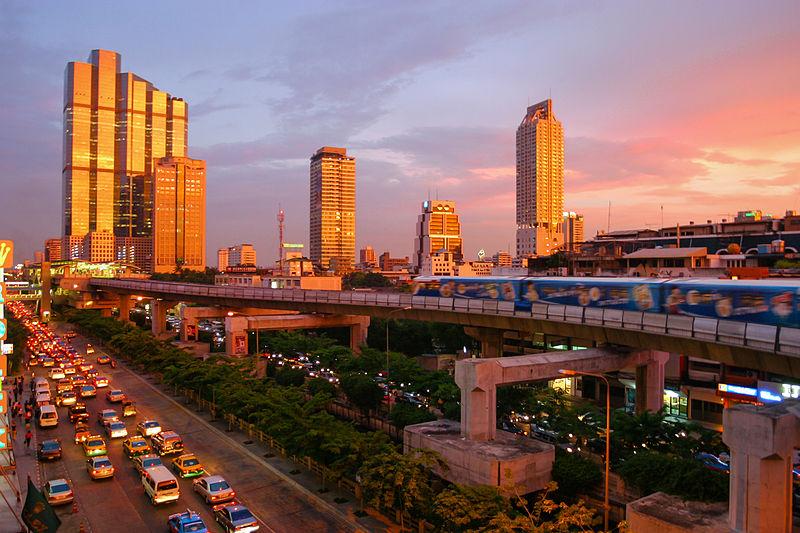 The BTS Skytrain passes through the business district of Sathon. The Robot Building (centre-right) was completed in 1986 and is a symbol of Bangkok's rapid growth in the mid-1980s.